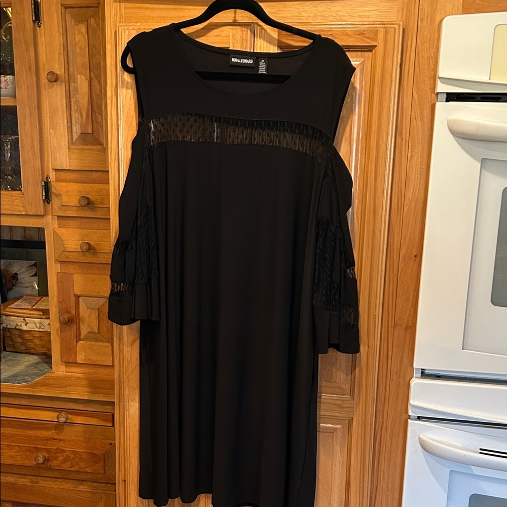 Pretty and fun black dress! See elegant lace accents and open shoulder design.